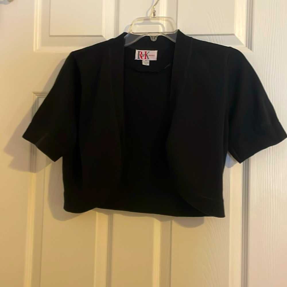 R&K Originals black shrug sweater. Cute over a sleeveless dress or top. Size M.